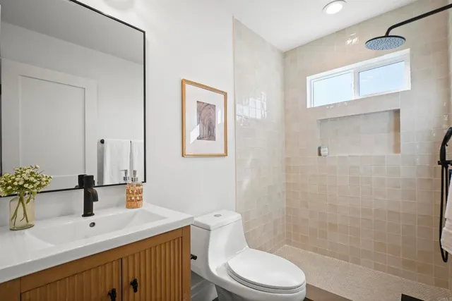 a bathroom with a sink a toilet and shower