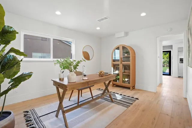 a view of a workspace with furniture window and wooden floor