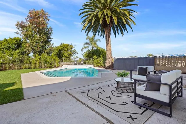 a view of a backyard with couches chairs and a small yard