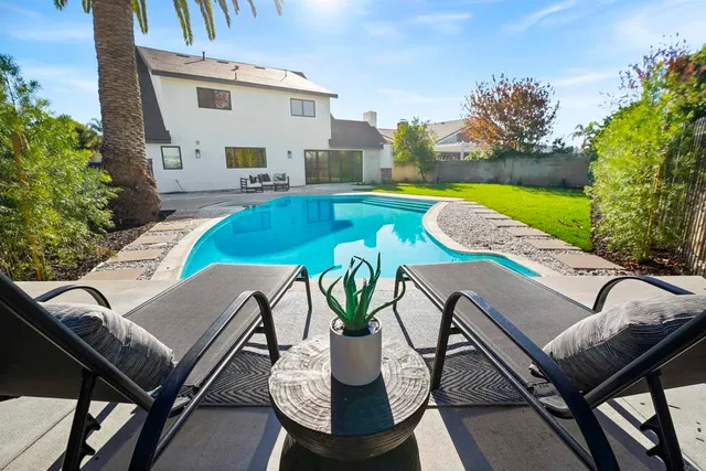 a view of a swimming pool with furniture