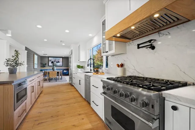 a kitchen with stainless steel appliances granite countertop a stove and a refrigerator
