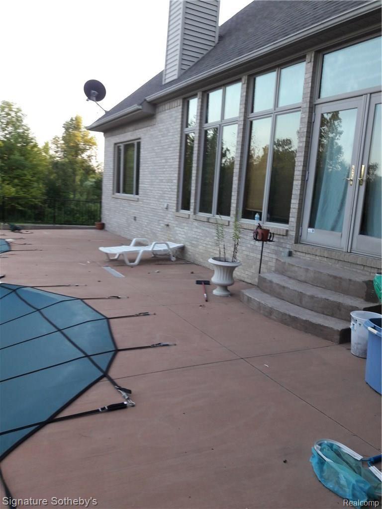 5000 Lake Pleasant Road North Branch, MI 48461 - Photo 22 of 34 Stepping out from the living room common area into the pool deck. Who needs to leave and go the the beach when you have your own tropical paradise right at home >>>