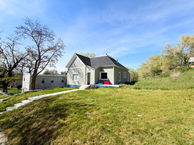 548 27th Street Ogden, UT 84403 - Photo 2 of 13 View of front of home featuring board and batten siding and a front yard