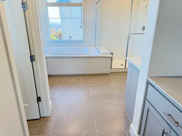 a large kitchen with stainless steel appliances kitchen island a large counter top and a stove top oven