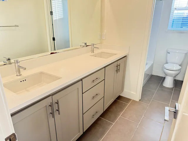 a bathroom with a sink a toilet and a tub