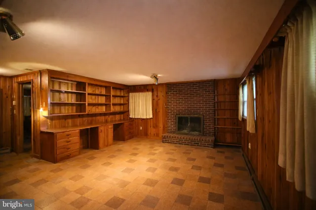 a view of a livingroom with furniture and staircase