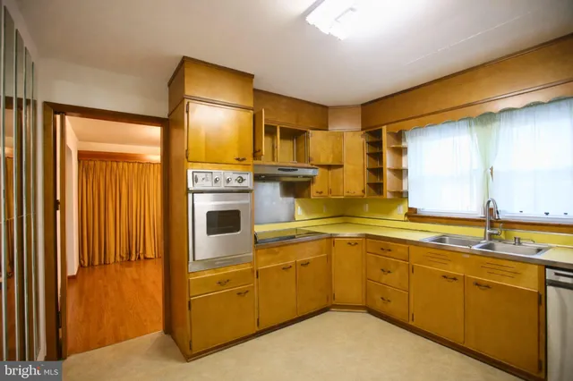 a kitchen with stainless steel appliances granite countertop a sink and cabinets