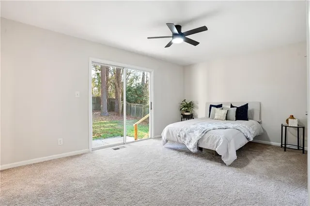 a spacious bedroom with a bed and a large window