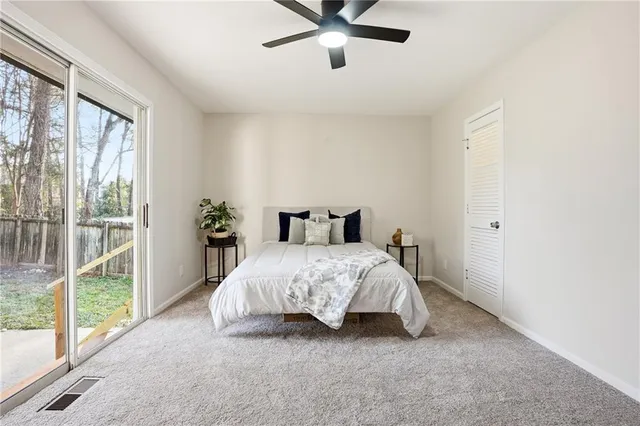 a bedroom with a bed and large window