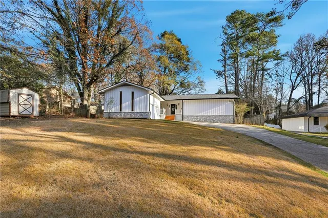 a house that has a tree in front of it