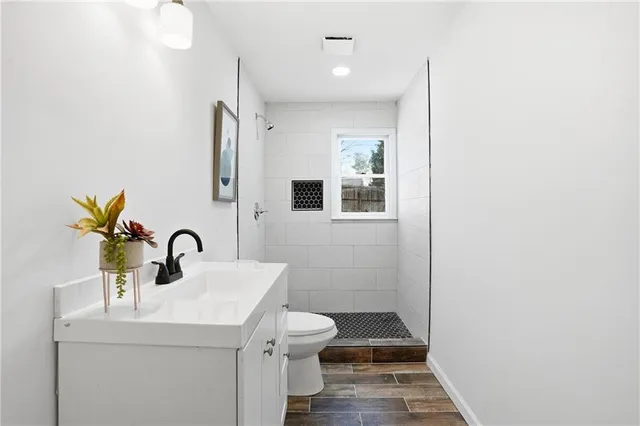 a bathroom with a sink toilet and shower