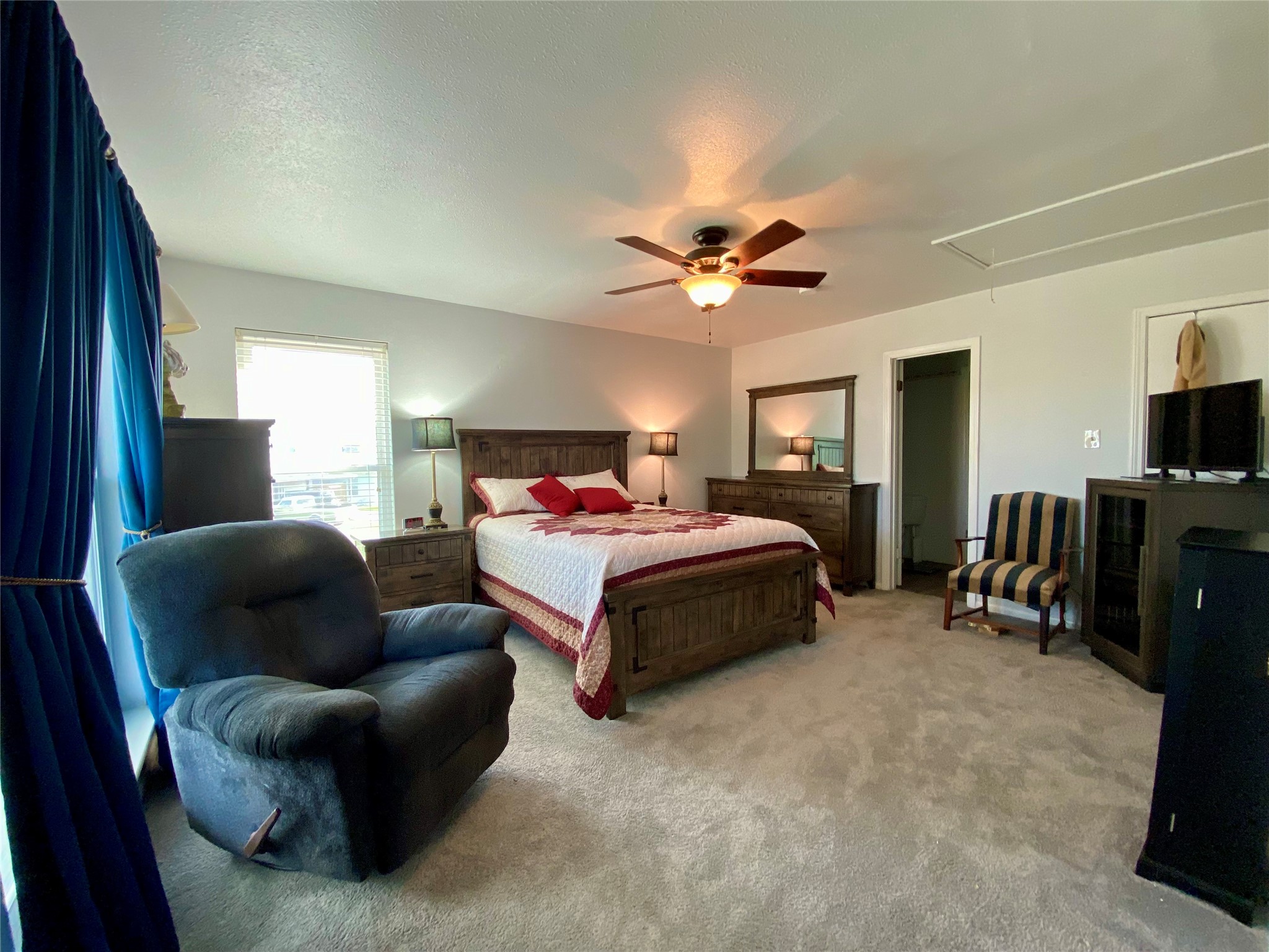 102 Redfish Drive Freeport, TX 77541 - Photo 14 of 44 a spacious bedroom with a bed a window and a couch