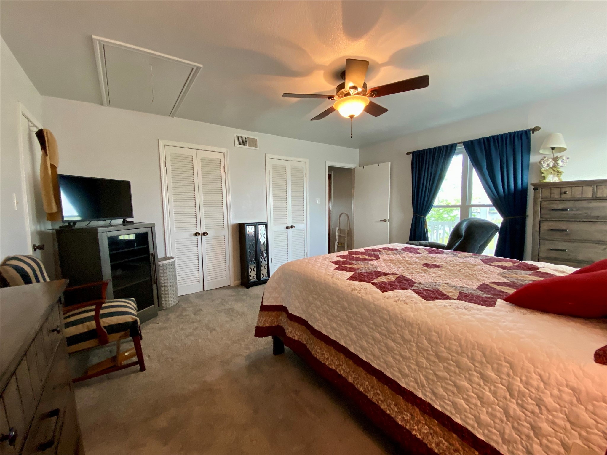 102 Redfish Drive Freeport, TX 77541 - Photo 15 of 44 a bedroom with a bed flat screen tv and a large window