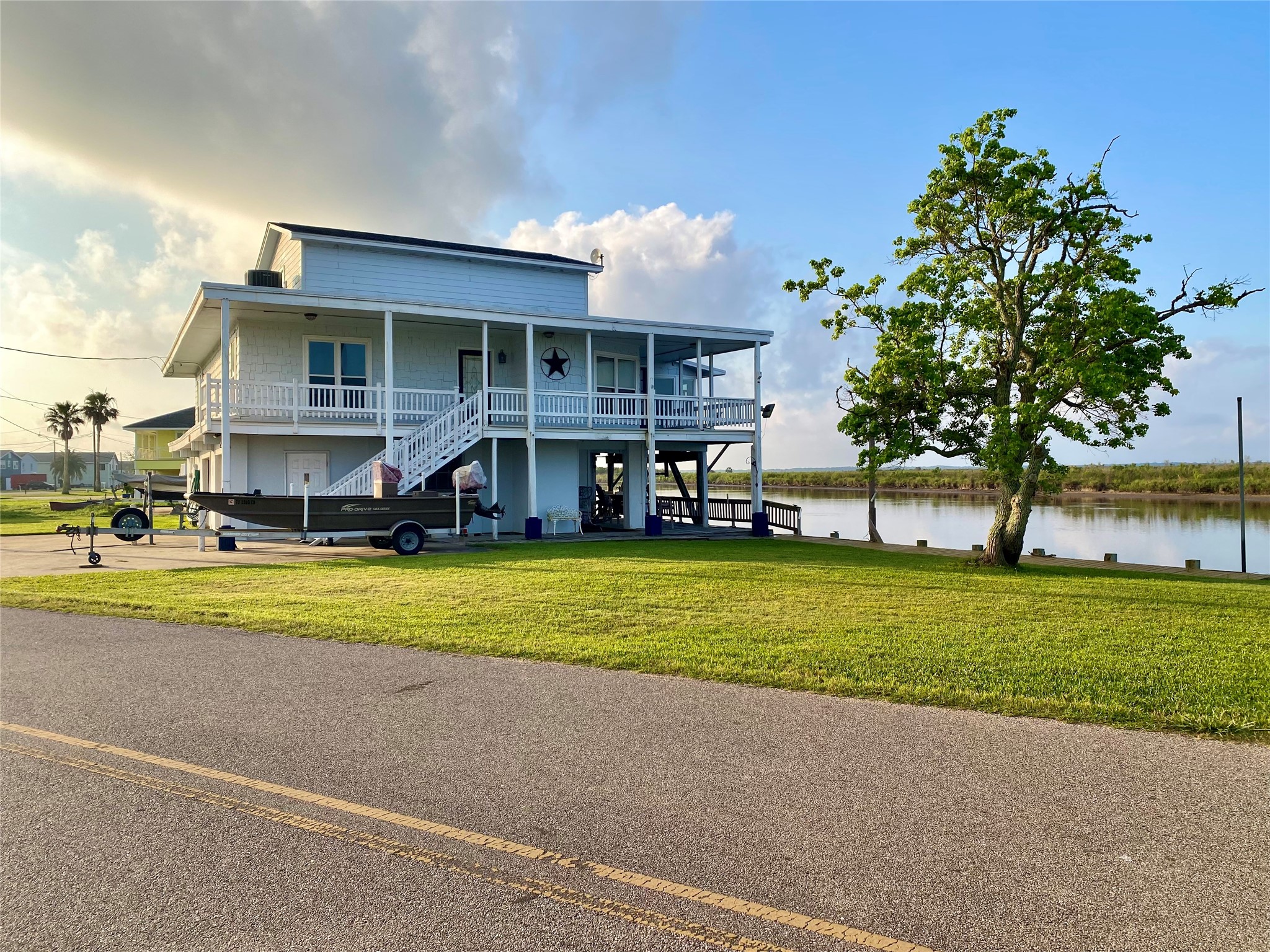 102 Redfish Drive Freeport, TX 77541 - Photo 2 of 44 a front view of a house with a yard table and chairs