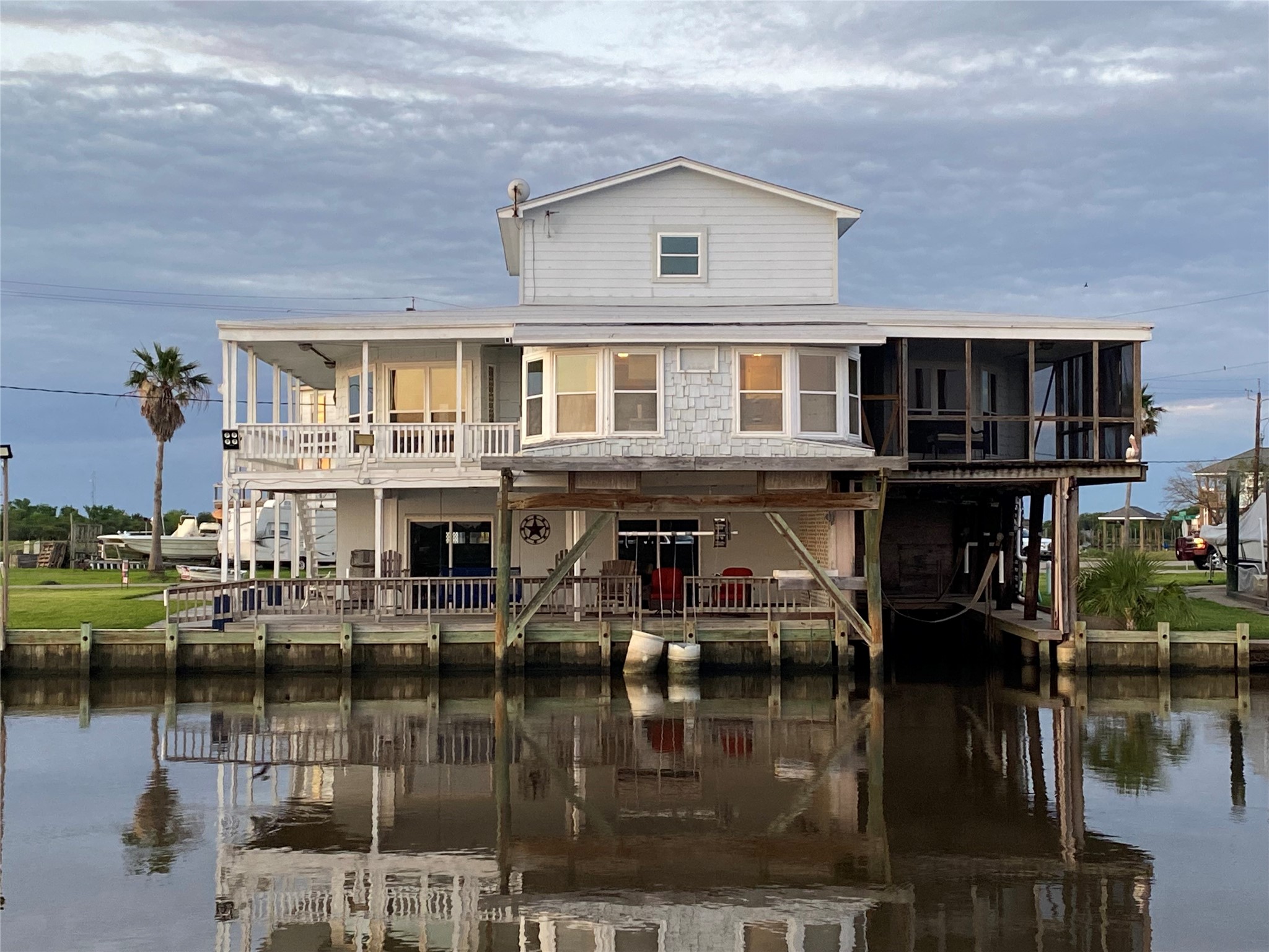 102 Redfish Drive Freeport, TX 77541 - Photo 3 of 44 a front view of a house with lake view