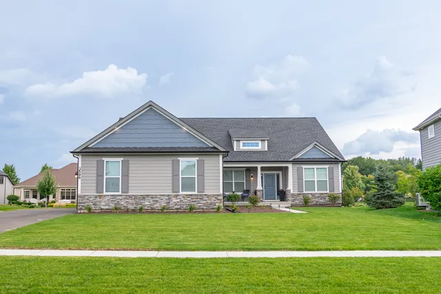 a front view of a house with a garden