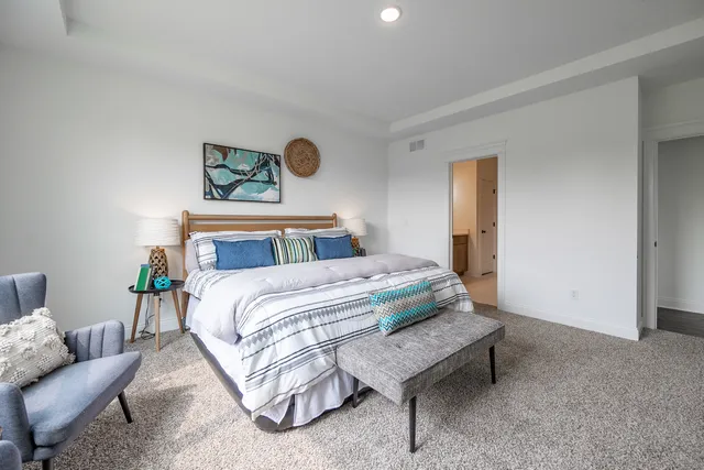 a bedroom with a bed and couch