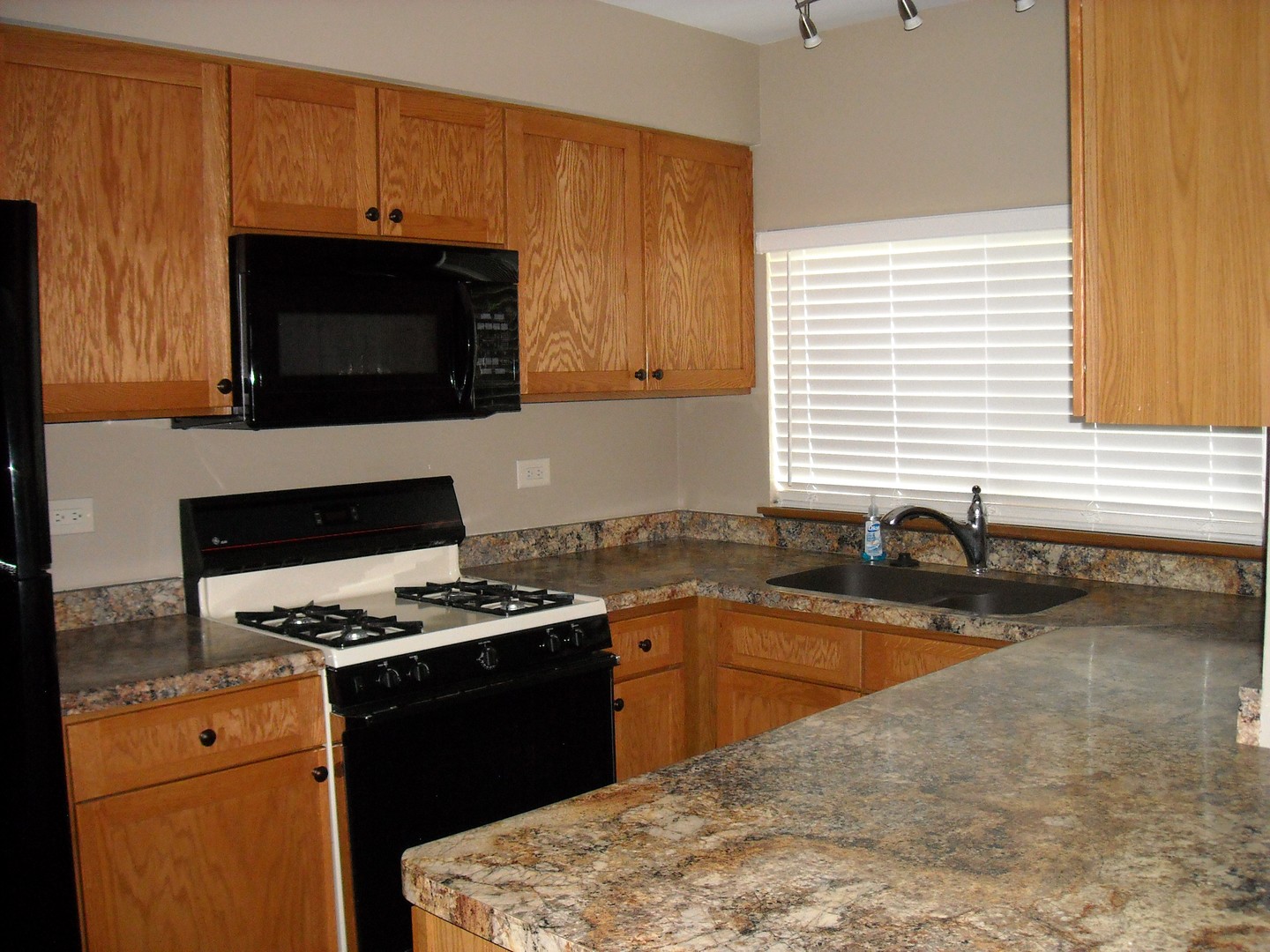 Undisclosed Address Aurora, IL 60504 - Photo 2 of 12 a kitchen with granite countertop a stove and a sink