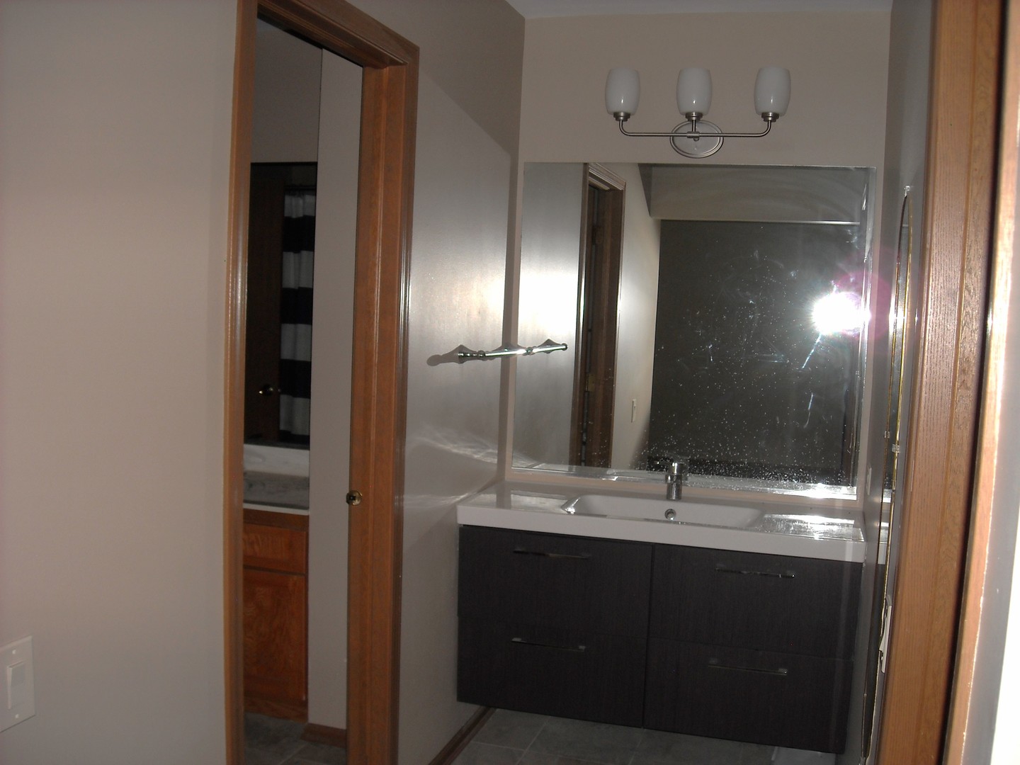 Undisclosed Address Aurora, IL 60504 - Photo 6 of 12 a bathroom with a double vanity sink and a mirror