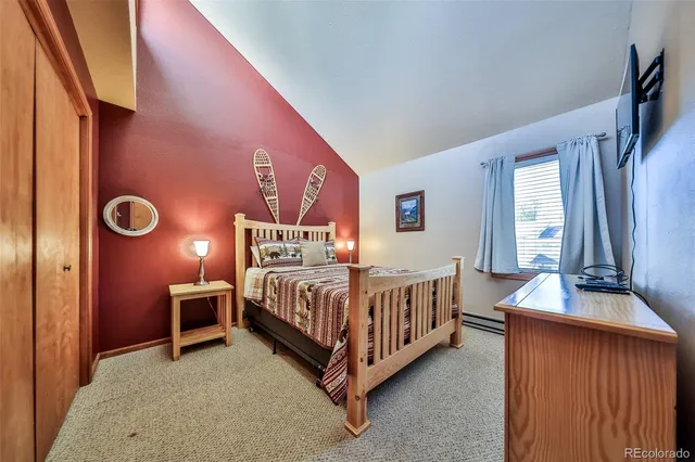 a bed room with a bed and a chair