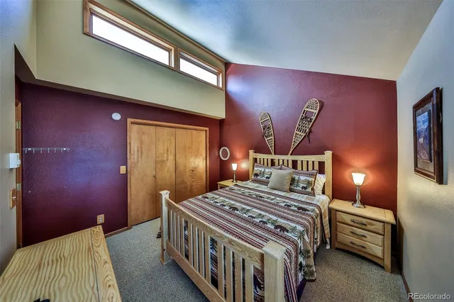 a bedroom with a bed and a night stand