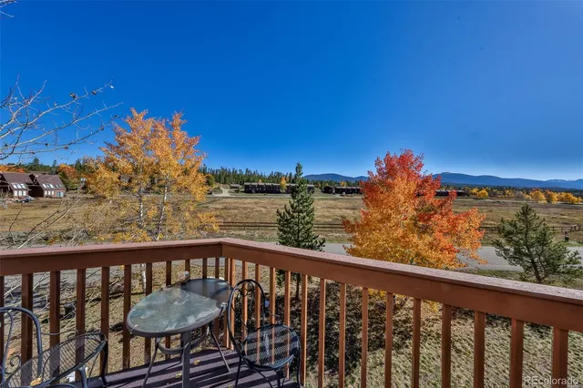 a view of a balcony with wooden chairs and floor