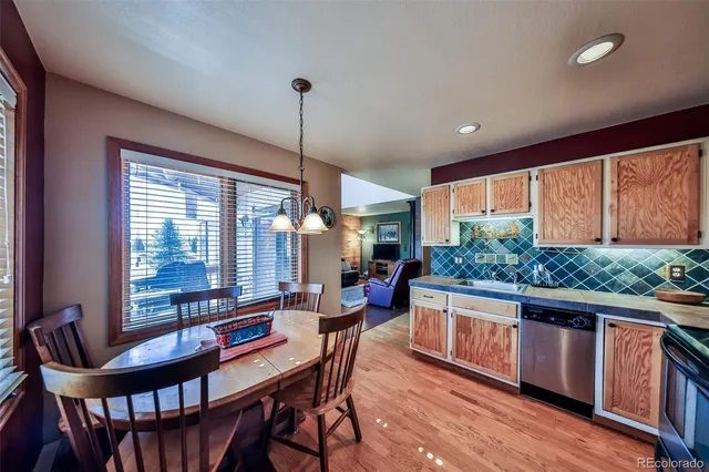 a dining room with furniture window and wooden floor