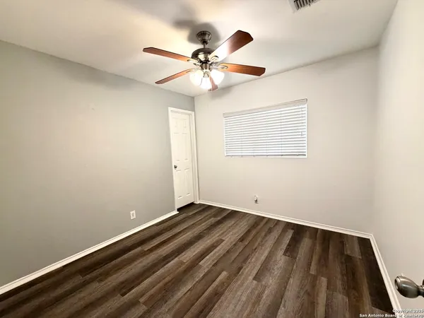 a view of room with window and ceiling fan