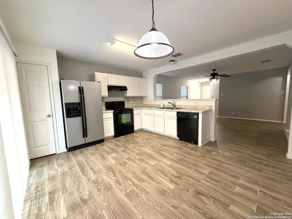 a view of a kitchen with a stove cabinets and wooden floor