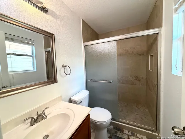 a bathroom with a sink toilet and shower