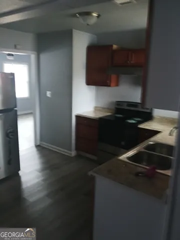 a kitchen with a sink and a stove top oven