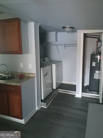 a kitchen with granite countertop a refrigerator and a sink