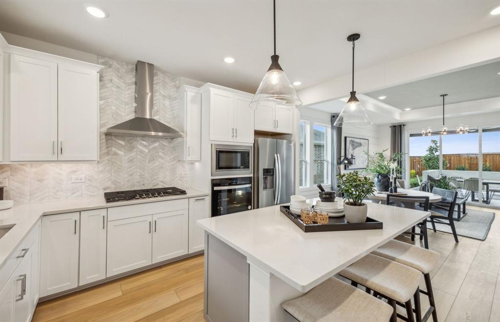405 Snowbird Way McKinney, TX 75071 - Photo 2 of 12 Spacious kitchen with eat-in bartop island