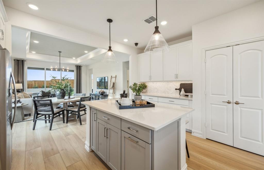 405 Snowbird Way McKinney, TX 75071 - Photo 5 of 12 Large island overlooking gathering room and dining areas