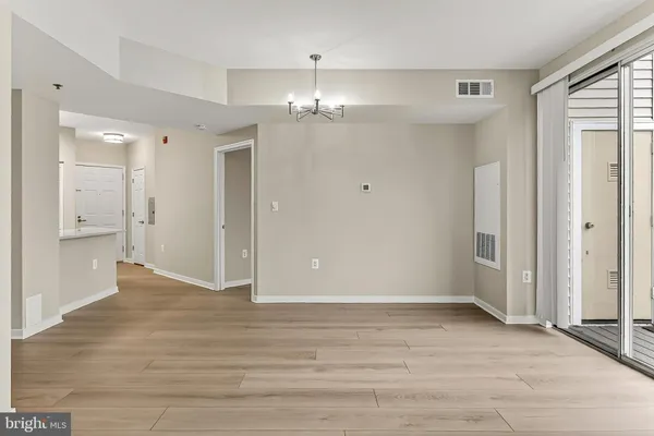 wooden floor in an empty room with a bathroom