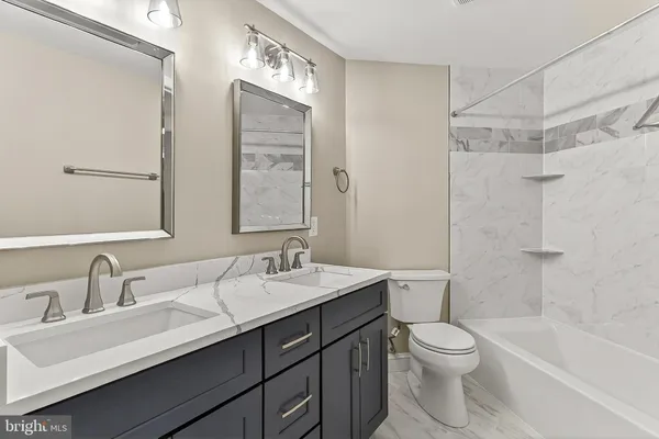 a bathroom with a sink toilet tub and shower