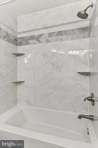 a living room with a table chairs and wooden floor