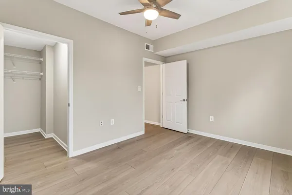 a view of an empty room and wooden floor