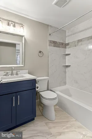 a bathroom with a sink toilet a mirror and shower