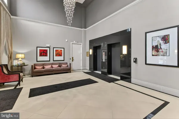 a spacious bedroom with a bed and a chandelier