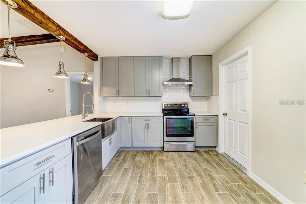612 Estrada Lane Kissimmee, FL 34758 - Photo 3 of 8 a kitchen with a stove and a refrigerator