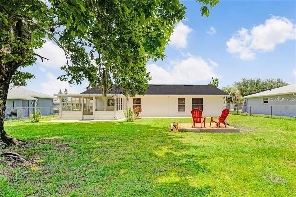 612 Estrada Lane Kissimmee, FL 34758 - Photo 7 of 8 a view of a house with backyard sitting area and garden