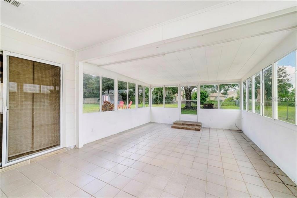 612 Estrada Lane Kissimmee, FL 34758 - Photo 8 of 8 a view of an empty room with a floor to ceiling window and a living room