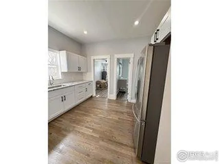 a kitchen with granite countertop a refrigerator and a stove