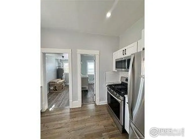 a kitchen with stainless steel appliances a stove a microwave and sink