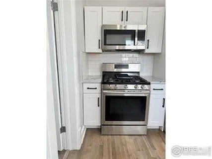 a kitchen with stainless steel appliances a refrigerator stove and sink