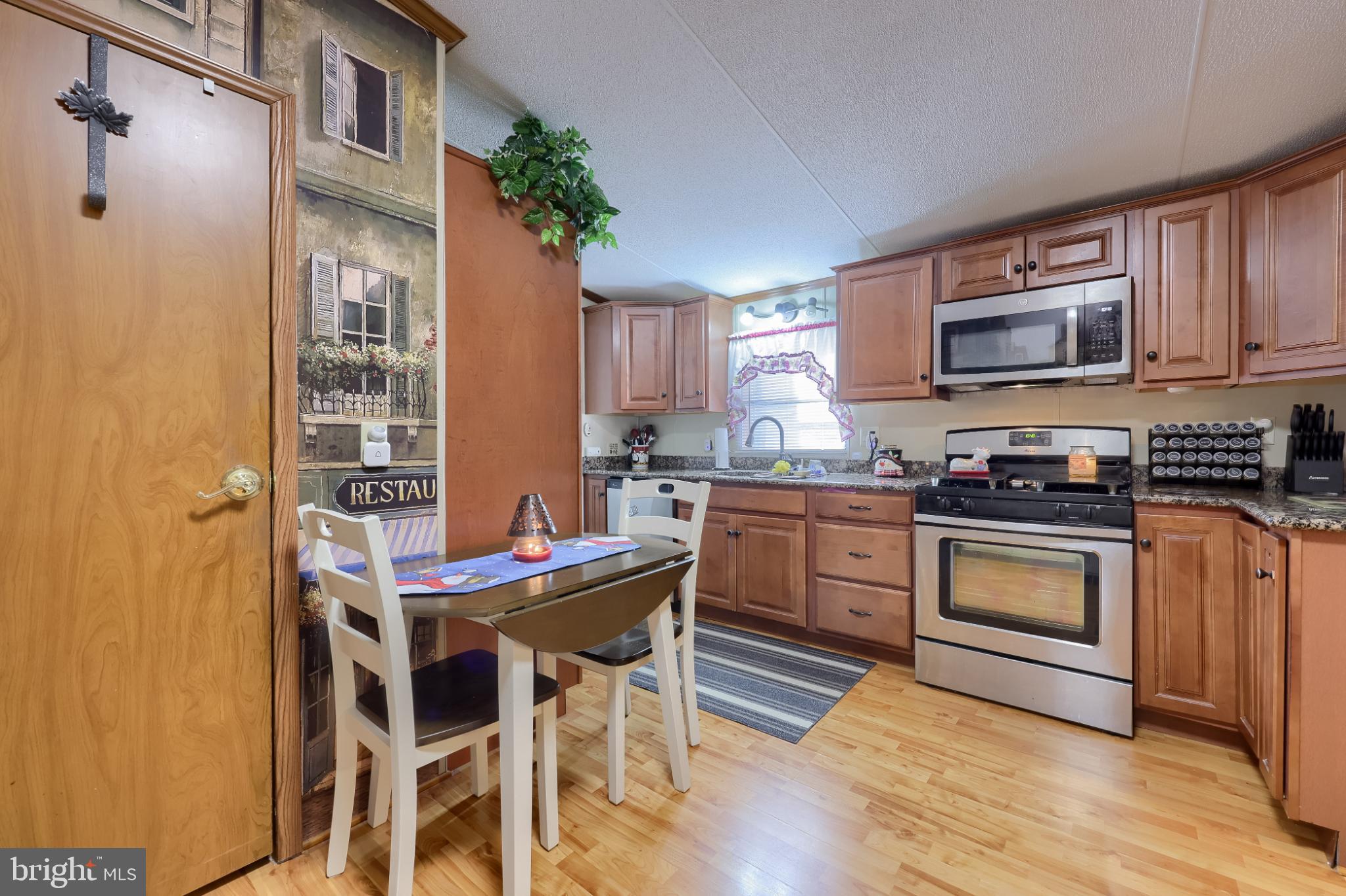 104 Fox Run Court Lancaster, PA 17603 - Photo 11 of 17 a kitchen with stainless steel appliances kitchen island granite countertop a stove a sink and a microwave