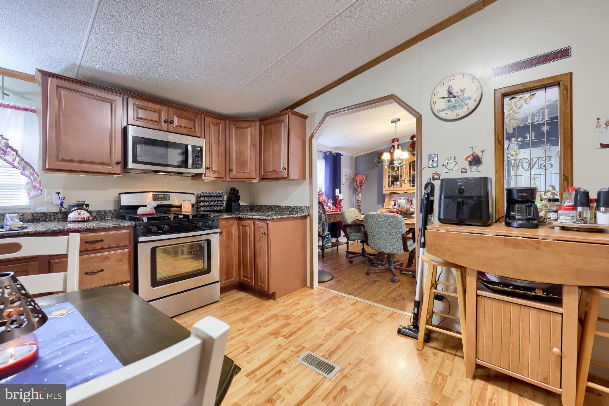 104 Fox Run Court Lancaster, PA 17603 - Photo 12 of 17 a open kitchen with granite countertop a stove top oven a sink a dining table and chairs