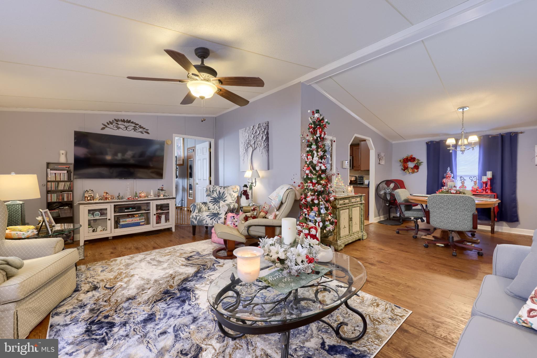 104 Fox Run Court Lancaster, PA 17603 - Photo 7 of 17 a living room with furniture a chandelier and a flat screen tv