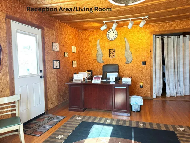a view of living room with furniture and wooden floor